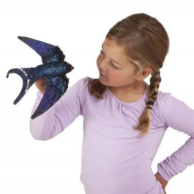 A young girl playing with a "Swallow" hand puppet A young girl playing with a "Swallow" hand puppet