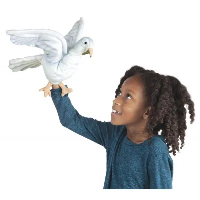 A young girl playing with a dove-shaped hand puppet A young girl playing with a dove-shaped hand puppet