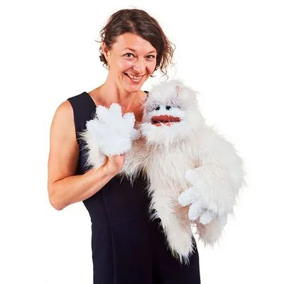 Woman operating a Folkmanis Yeti hand puppet
