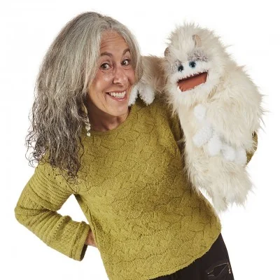 Woman operating a Folkmanis Yeti hand puppet