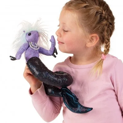 A young girl playing with a Folkmanis Sea Nymph finger puppet