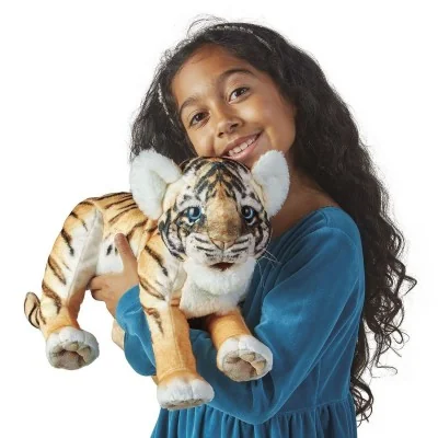 Young girl playing with a Folkmanis Baby Tiger hand puppet