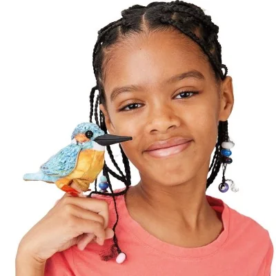 A young girl playing with a Folkmanis kingfisher mini puppet