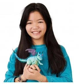 A young girl playing with a Folkmanis Mini Dragon puppet