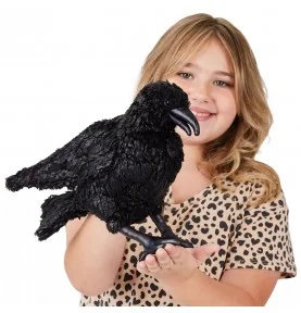 Girl playing with a Folkmanis raven puppet