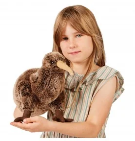 A young girl holding a Folkmanis kiwi hand puppet