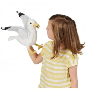 A young girl playing with a seagull puppet by Folkmanis
