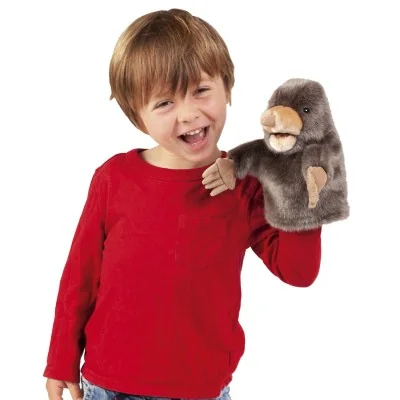 Boy playing with a Little Mole hand puppet